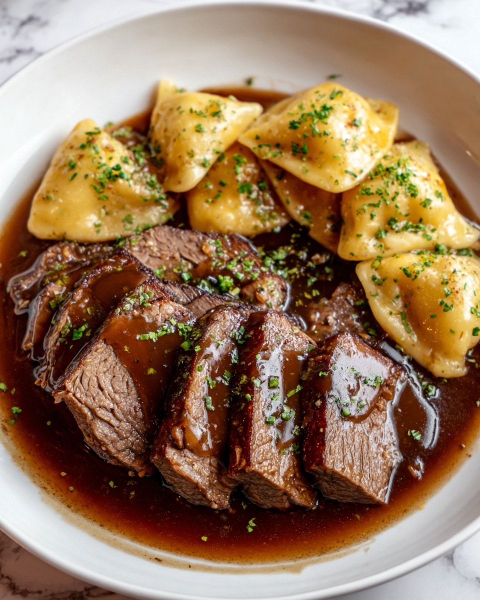 The image shows a white plate with several thick slices of dark brown beef covered in a rich, shiny brown sauce at the center. Around the beef, there are several soft, golden yellow dumplings sprinkled with green herbs. The sauce looks smooth and glossy, pooling at the bottom of the plate, enhancing the colors of the meat and dumplings. The entire scene is set against a white marbled surface. photo taken with an iphone --ar 4:5 --v 7